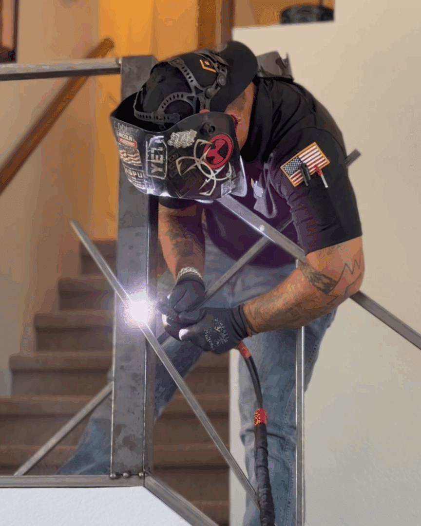 First Impression Ironworks welder attaching railing in a home