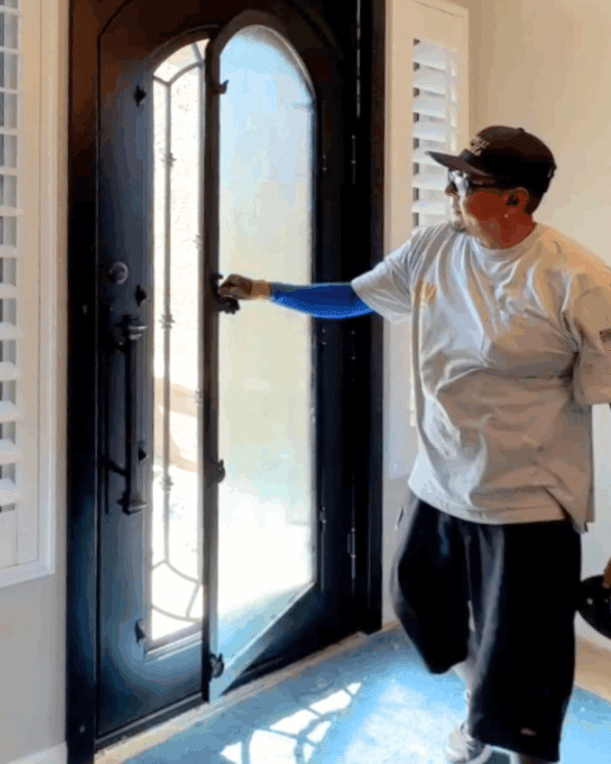 First Impression Ironworks team member doing quality control checks on a new iron door he is installing