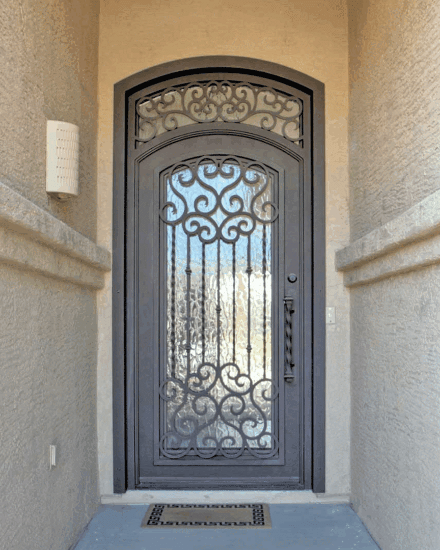 Large custom Iron Entry Door from First Impression Ironworks with intricate scrollwork and glass
