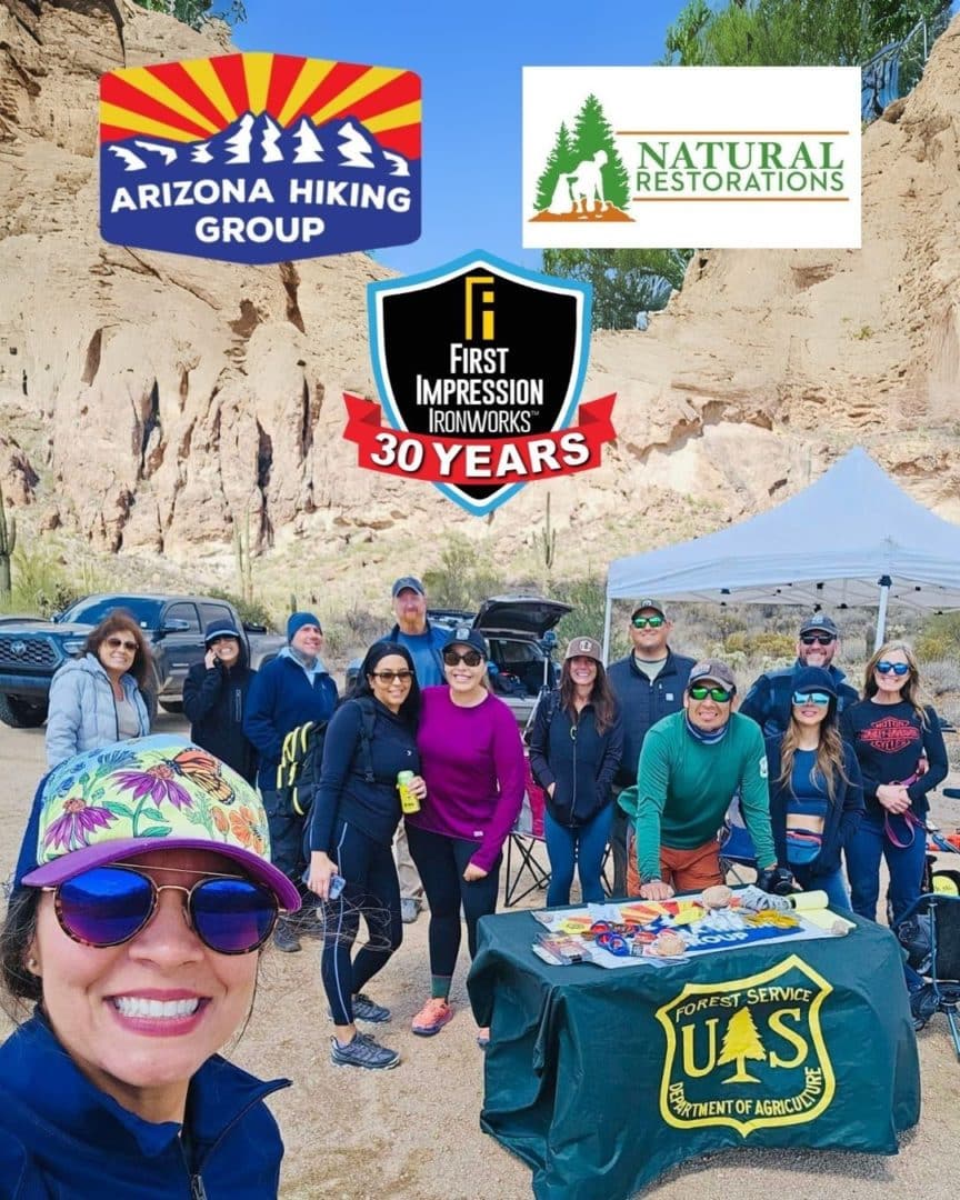Large group of First Impression Ironworks employees smiling for a picture at a Earth Day clean-up event
