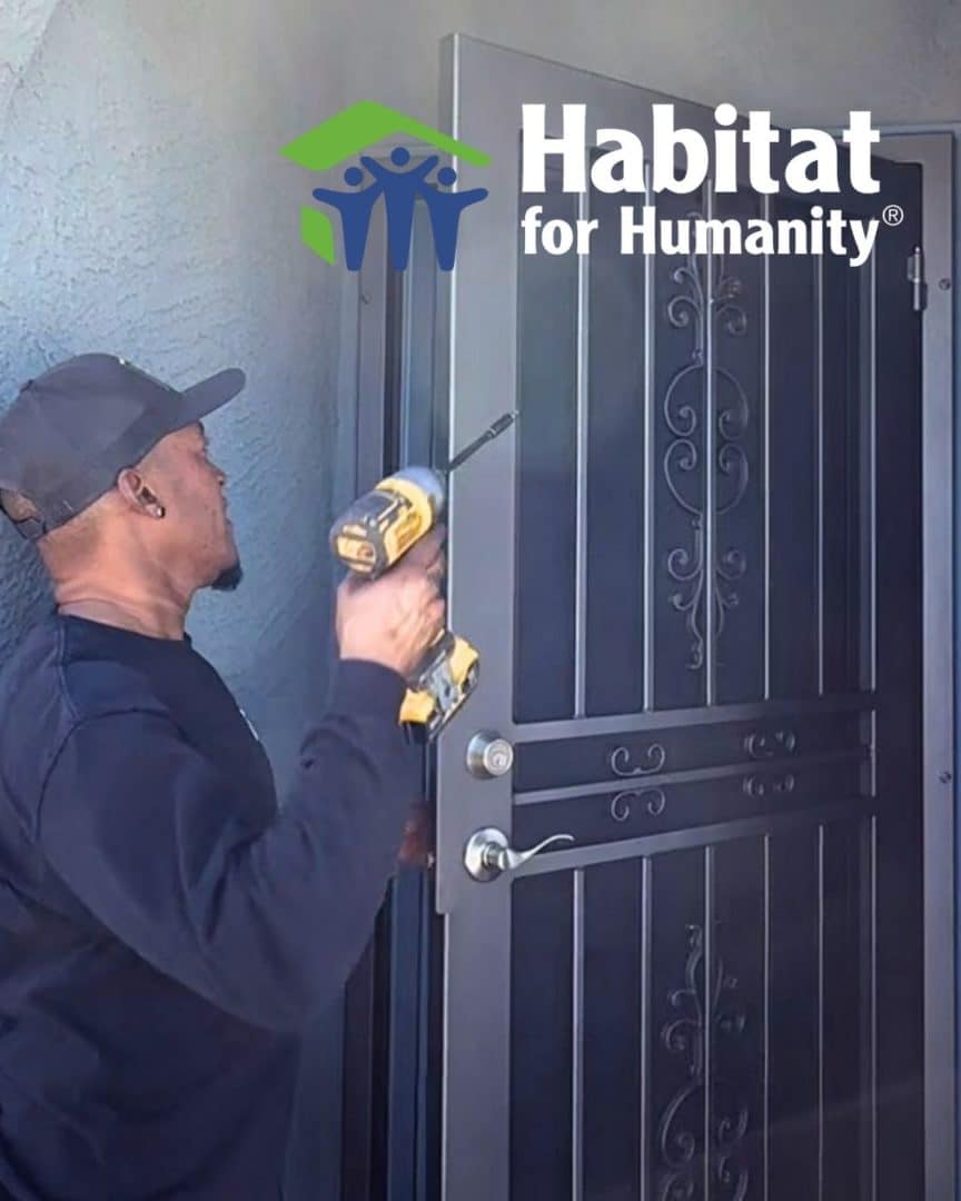 First Impression Ironworks Installation Specialist installing an iron security door at a Habitat for Humanity home