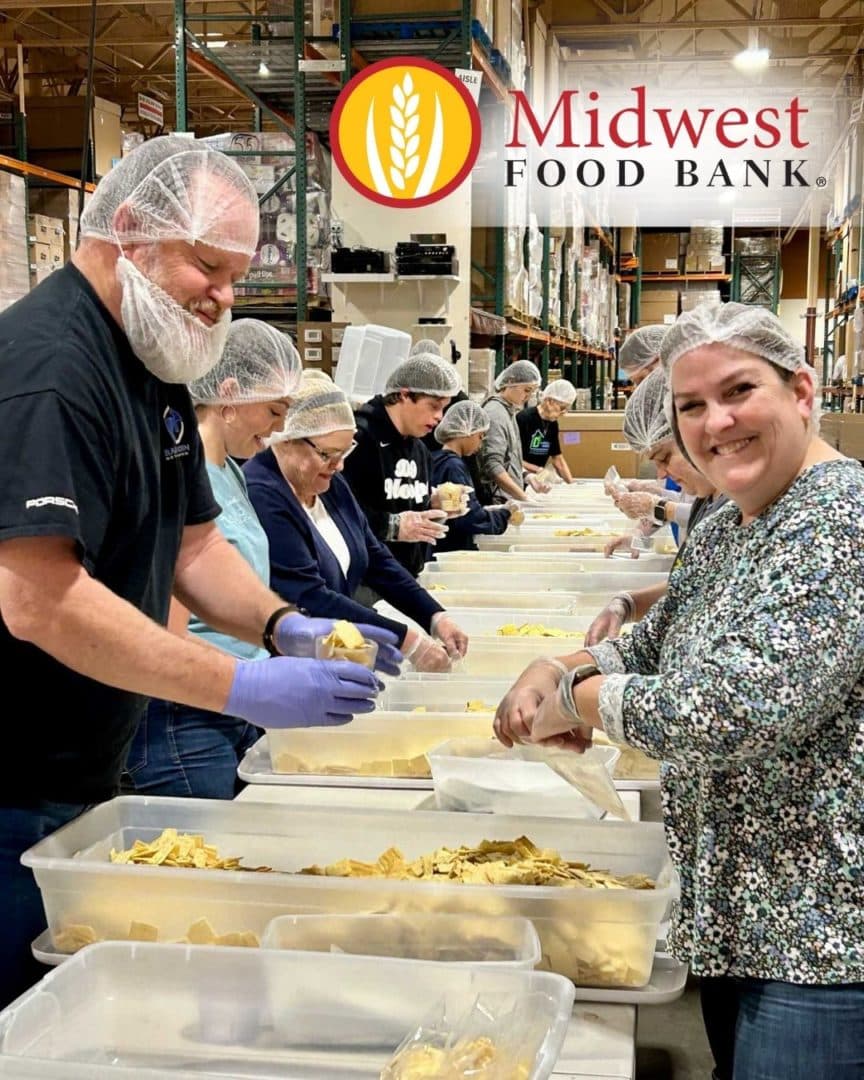 Group of First Impression Ironworks employees packing meals at Midwest Food Bank
