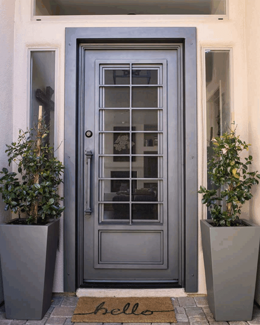 Modern black custom iron entry door with glass, custom made by First Impression Ironworks