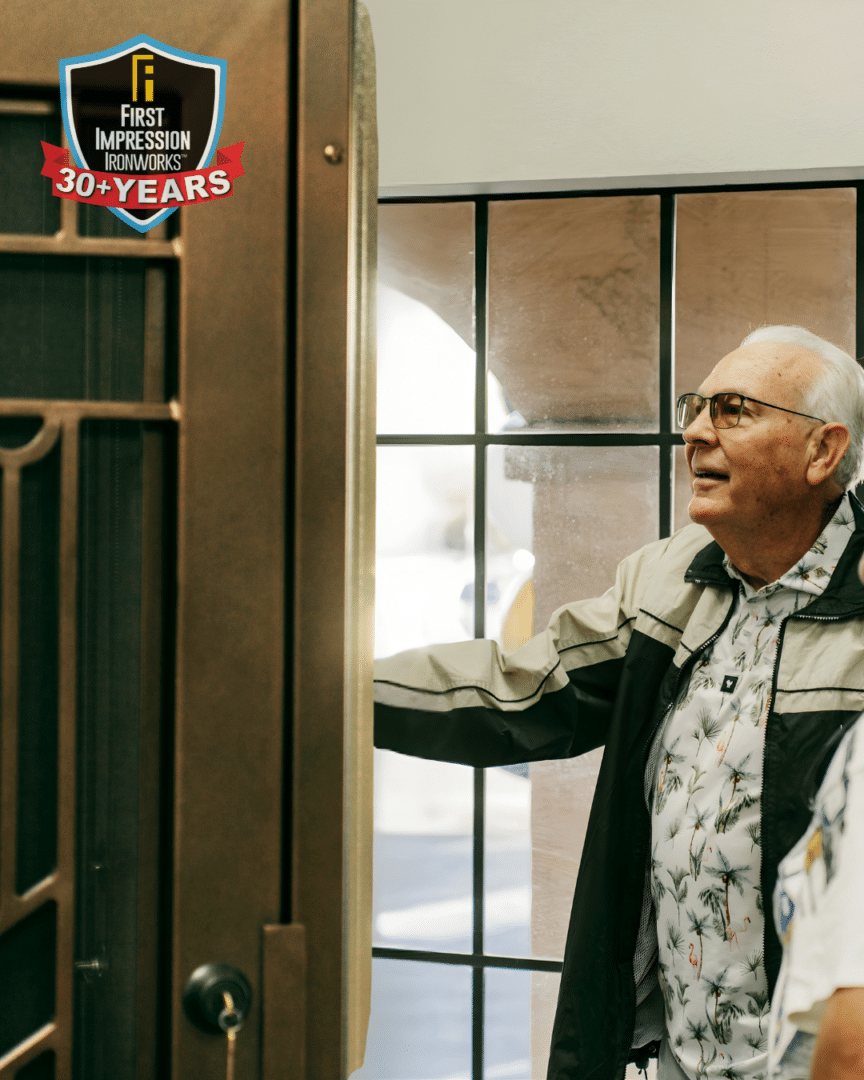 Man touching an iron door in a First Impression Ironworks showroom