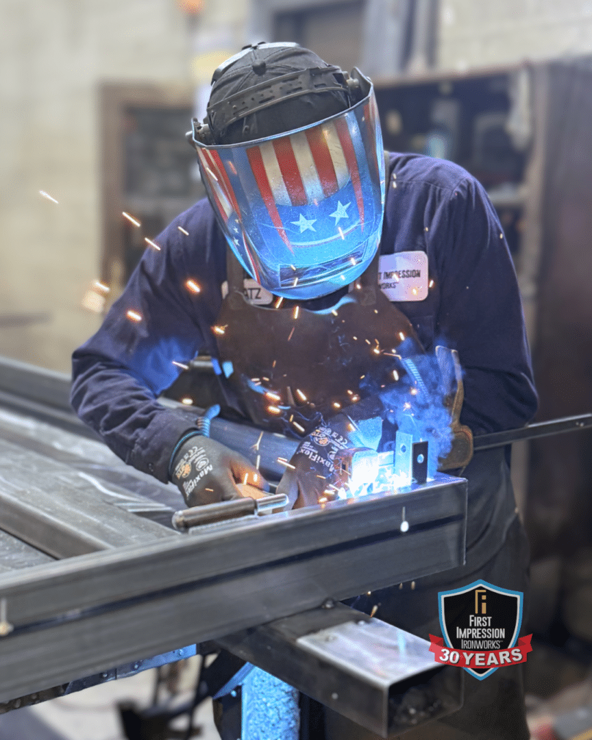First Impression Ironworks skilled welder working on an iron entry door